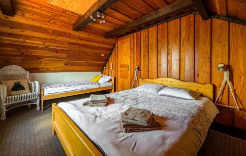 a bedroom with two beds in a wooden cabin at Villa Magic by Villas Guide in Jalžabet