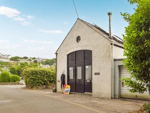 a building with a garage with a large door at The Boathouse in Little Haven