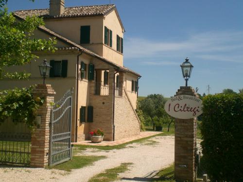 a gate to a house with a sign on it at I Ciliegi in Osimo