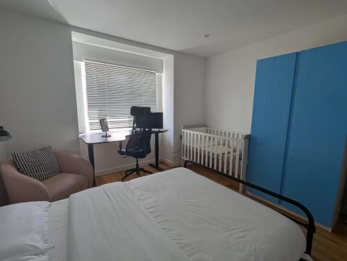 a bedroom with a bed and a desk and a chair at Wilmer House in Eastleigh