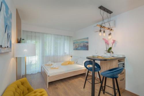 a living room with a bed and a table and chairs at Studio Apartment Nika in Split