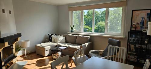a living room with a couch and a table at Viscosa Holiday Apartment in Kõrgessaare