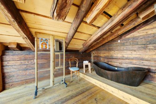 a large tub in a room with wooden walls at Cedä-M in Dosoledo