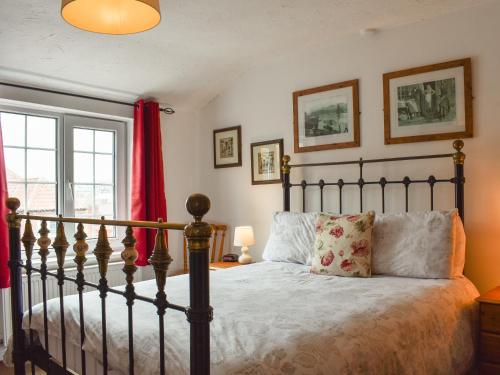 a bedroom with a bed and a window at Awd Tuts in Whitby