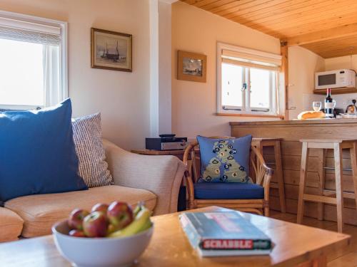 a living room with a bowl of fruit on a table at Fulmar in Dungeness