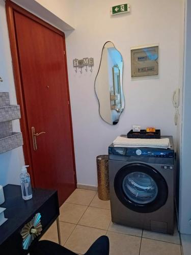 a room with a washing machine and a mirror at Sun in Sitia