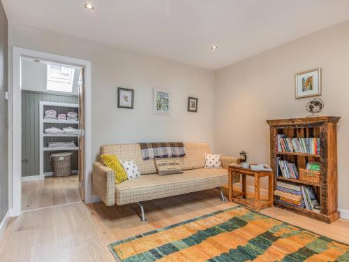 a living room with a couch and a book shelf at The Granary - Uk34899 in Dunira