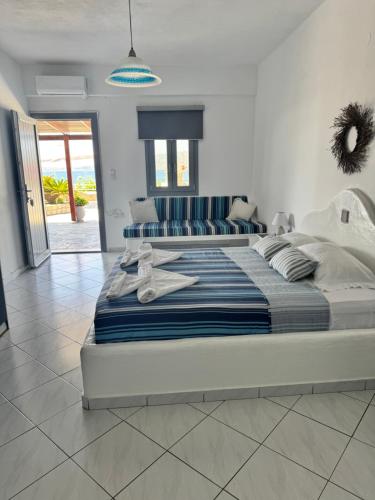 a bedroom with a large bed with towels on it at Christos rooms milos in Adamantas