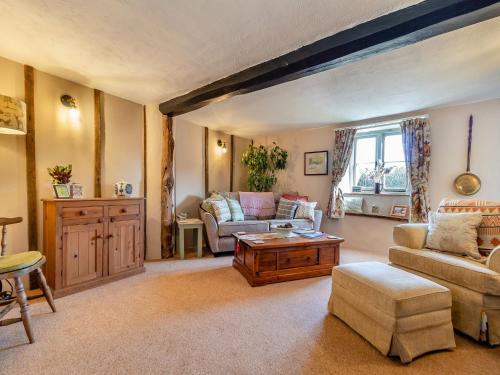 a living room with a couch and a table at Cherry Tree Cottage - Uk30237 in Great Snoring