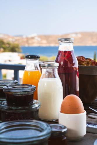 a group of bottles of milk and eggs on a table at Medusa Accommodation in Livadakia