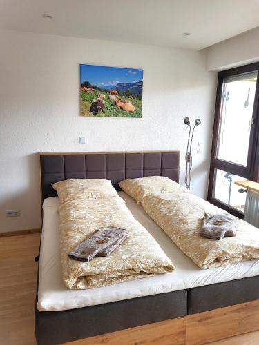 a bed with two pillows on it in a room at Ferienwohnung Zum Hochgrat in Oberstaufen