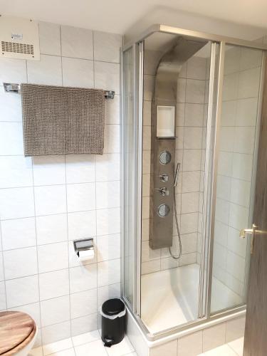 a shower with a glass door in a bathroom at Ferienwohnung Zum Hochgrat in Oberstaufen