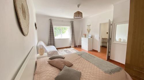 a bedroom with a bed with pillows on it at Casa do Jardim in Palmela