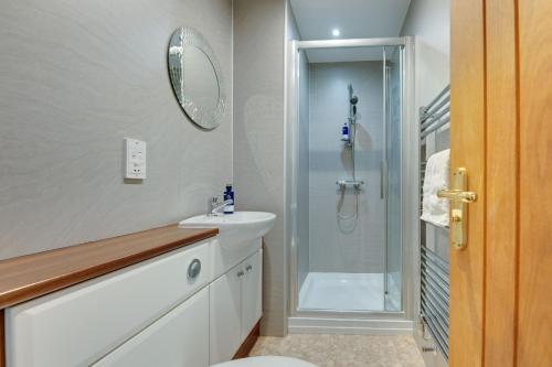 a bathroom with a sink and a shower at The Grain Rooms at Spindlestone in Lucker