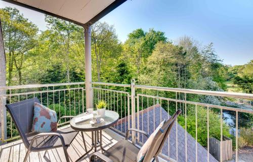 a porch with two chairs and a table on a balcony at The Grain Rooms at Spindlestone in Lucker