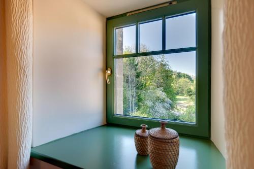 two vases sitting in front of a window at The Grain Rooms at Spindlestone in Lucker