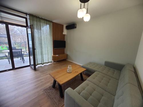 a living room with a couch and a table at Вила Фамилия - Villa Family in Lozenets