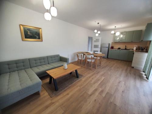 a living room with a couch and a table at Вила Фамилия - Villa Family in Lozenets