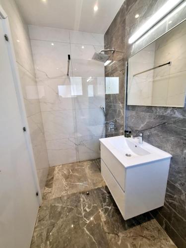 a bathroom with a white sink and a shower at Panorama Luxury Summer Villa in Protaras