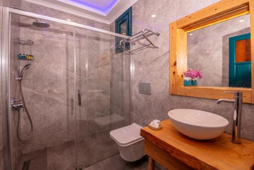 a bathroom with a shower and a sink and a toilet at Symbola Oludeniz Beach Hotel in Oludeniz