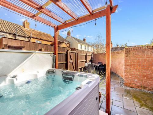 a hot tub on the patio of a house at The Old Jolly in Wainfleet All Saints