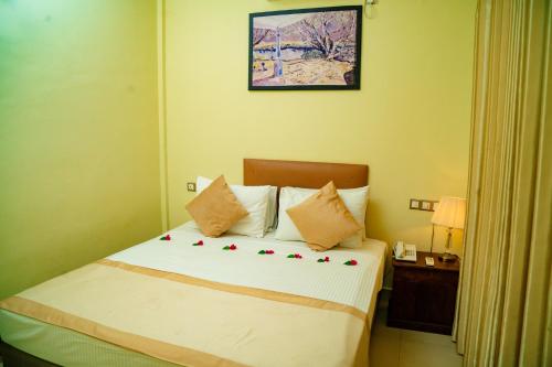 a bedroom with a bed with roses on it at Sungreen Resort Habarana in Habarana