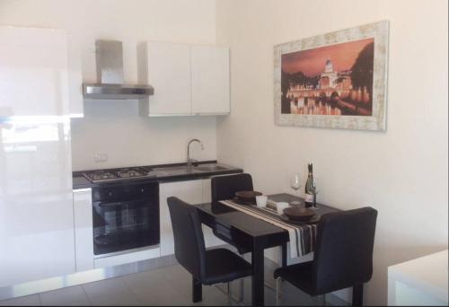 a kitchen with a black table and chairs and a stove at Ara-Home in Aranova