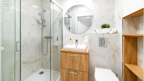 a bathroom with a shower and a sink and a mirror at Apartamenty Good Time - Belle View - Centrum in Szklarska Poręba