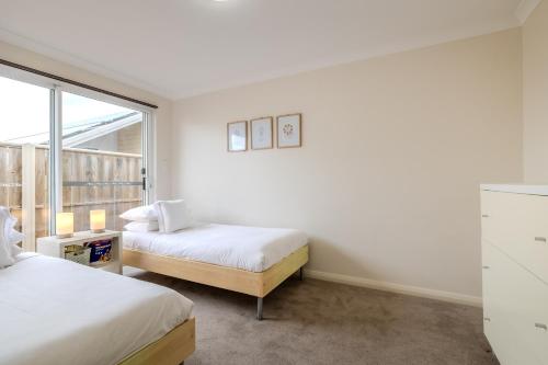 a bedroom with two beds and a window at Albany Bayside by the BnB Collection in Albany