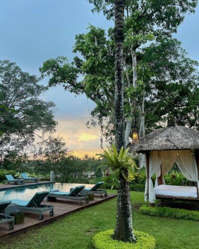 a resort with a pool and a gazebo at The Hidden Paradise Ubud - CHSE Certified in Ubud