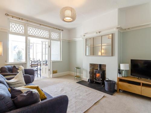 a living room with a couch and a fireplace at Court House in Porthcawl