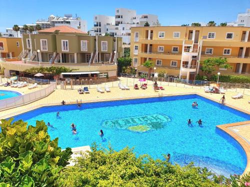 a large swimming pool with people in a resort at Apartment Orlando Sea in Adeje