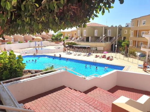 a large swimming pool with people in the water at Apartment Orlando Sea in Adeje