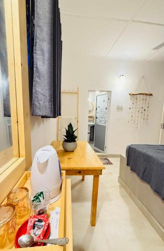 a living room with a table and a bed at Sun Shine Guest House in Negombo