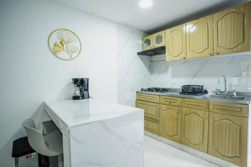 a kitchen with wooden cabinets and a white counter top at Casa Fonla in Estación El Salto