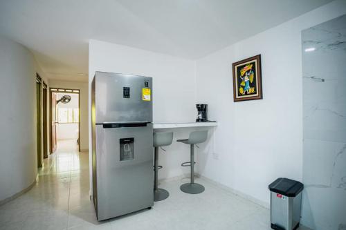 a kitchen with a sink and a refrigerator at Casa Fonla in Estación El Salto