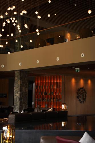 a bar in a restaurant with chairs and lights at Swissôtel Damian Jasna in Demanovska Dolina