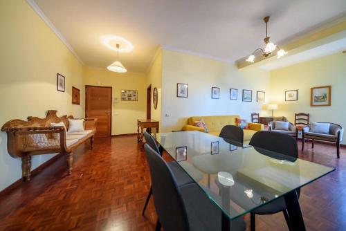 a living room with a table and a couch at Casa Branca Apartment by Mth in Funchal