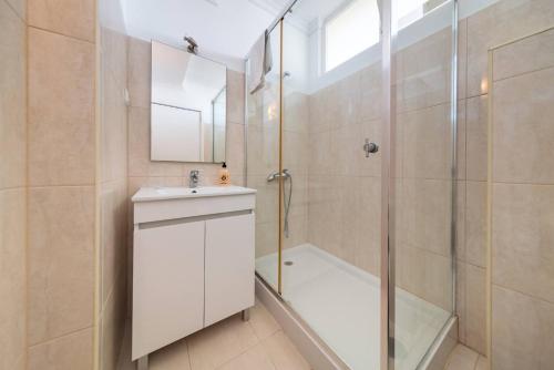a bathroom with a shower and a sink and a mirror at Casa Branca Apartment by Mth in Funchal