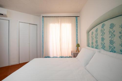Кровать или кровати в номере Cerbiatta al Molo Apartments by Wonderful Italy