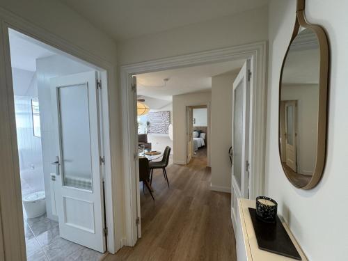 a hallway with a mirror and a dining room at Doña Carmen en el corazón Cangas Onís VUT-6783-AS in Cangas de Onís