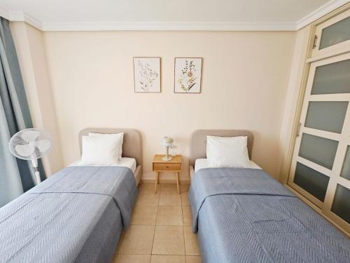 a bedroom with two beds and a window at Summer breeze in Puerto de Santiago