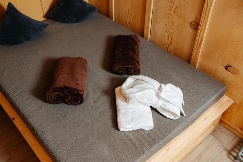 a bed with two rolled towels and a towel at Landhotel Berger in Ainring