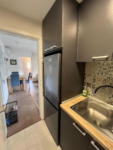 a kitchen with a stainless steel refrigerator and a sink at Vasilija in Sremski Karlovci
