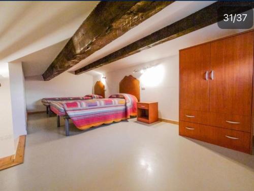 a bedroom with two beds and a dresser at Residenza le Saline in Comacchio