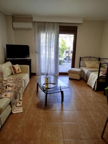 a living room with a couch and a coffee table at THANground floor in Nea Kalikratia