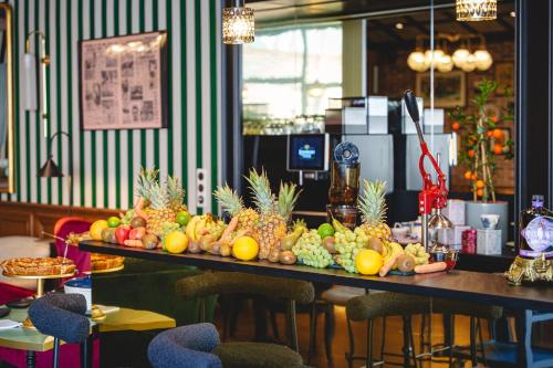 a table with a bunch of fruits on it at The Originals Boutique, Hôtel Le Londres, Saumur in Saumur