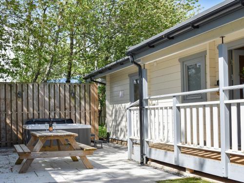 a patio with a picnic table and a house at Oak Lodge - Uk30005 in Lindal in Furness