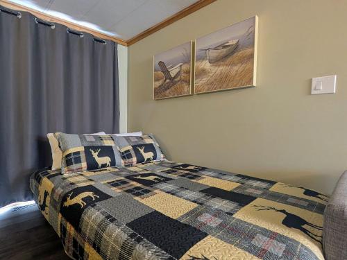 a bedroom with a bed with a quilt on it at Hillcrest Hideaway: Spacious Mountain View Oasis in Hillcrest Mines