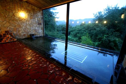 a room with a large window with a view of a pool at Senkyo in Numata